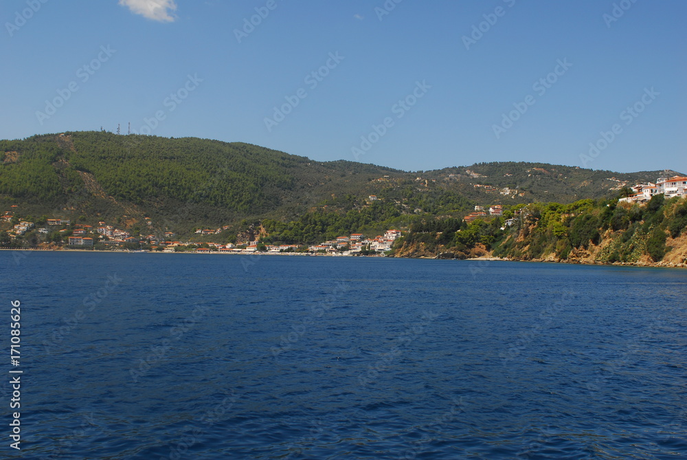 Skiathos town on Skiathos Island, Greece. Beautiful view of the old town with boats in the harbor. Skiathos town on Skiathos Island, Greece. Beautiful view of the old town with boats in the harbor.