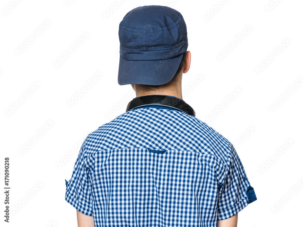 Portrait of young student with cap and headphones, isolated on white background. Close-up of back view. Portrait of young student with cap and headphones, isolated on white background. Close-up of back view.