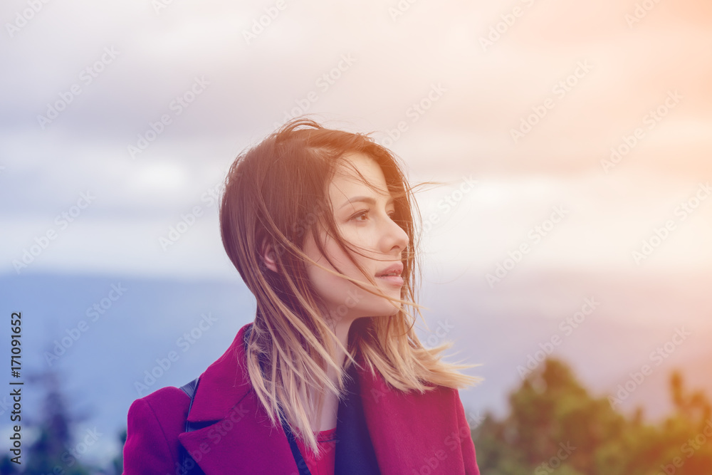 Young redhead woman in red coat stay at outdoor Young redhead woman in red coat stay at outdoor