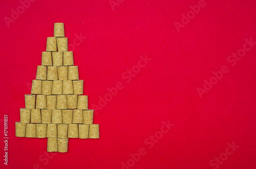 Fundo natalino vermelho com árvore de natal feita com rolhas photo