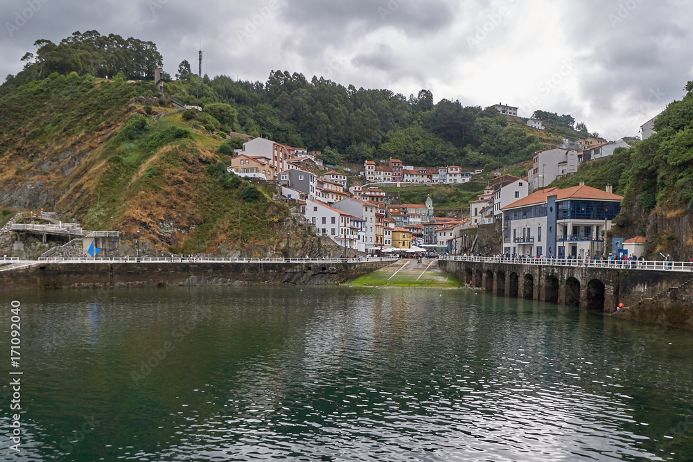View from Cudillero harbour in the north of spain with blue sky and white clouds