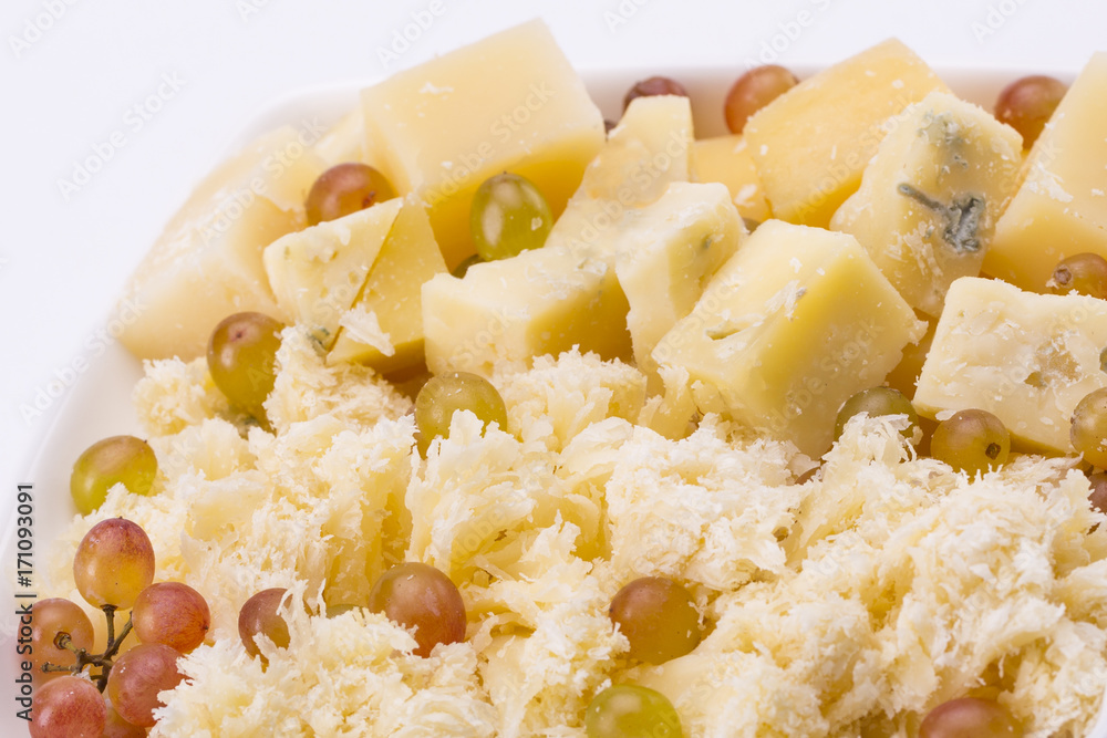 Set of cheeses and grapes on a white background Set of cheeses and grapes on a white background