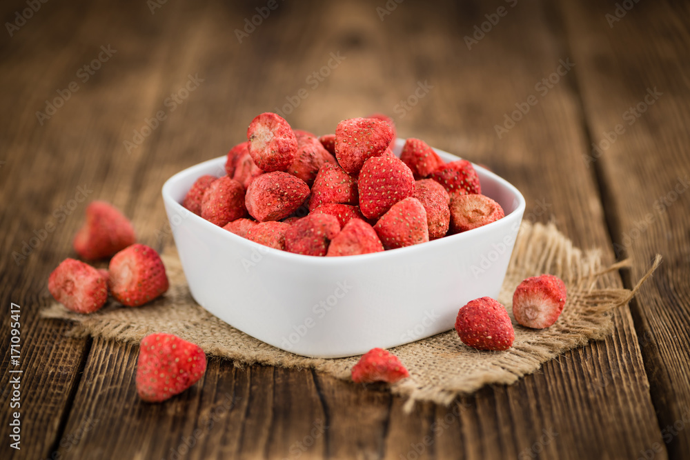 Strawberries (dried) on wooden background; selective focus Strawberries (dried) on wooden background; selective focus