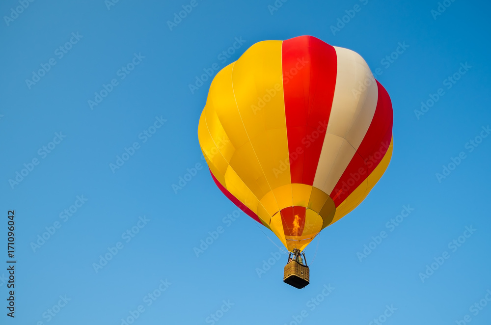 Fototapeta premium Colorful of Hot air balloon with fire and blue sky background