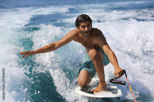Canvas Print Young man surfing on the wave.