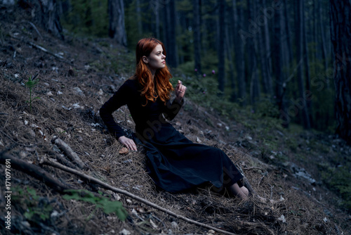 woman in a long black dress in the forest © SHOTPRIME STUDIO