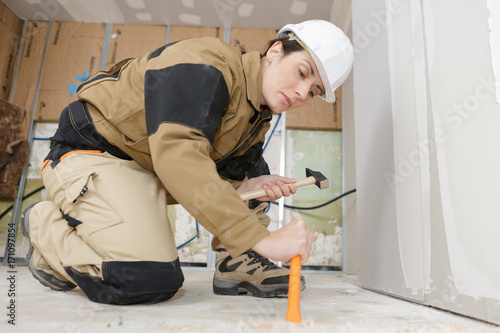 woman using a hammer and chisel