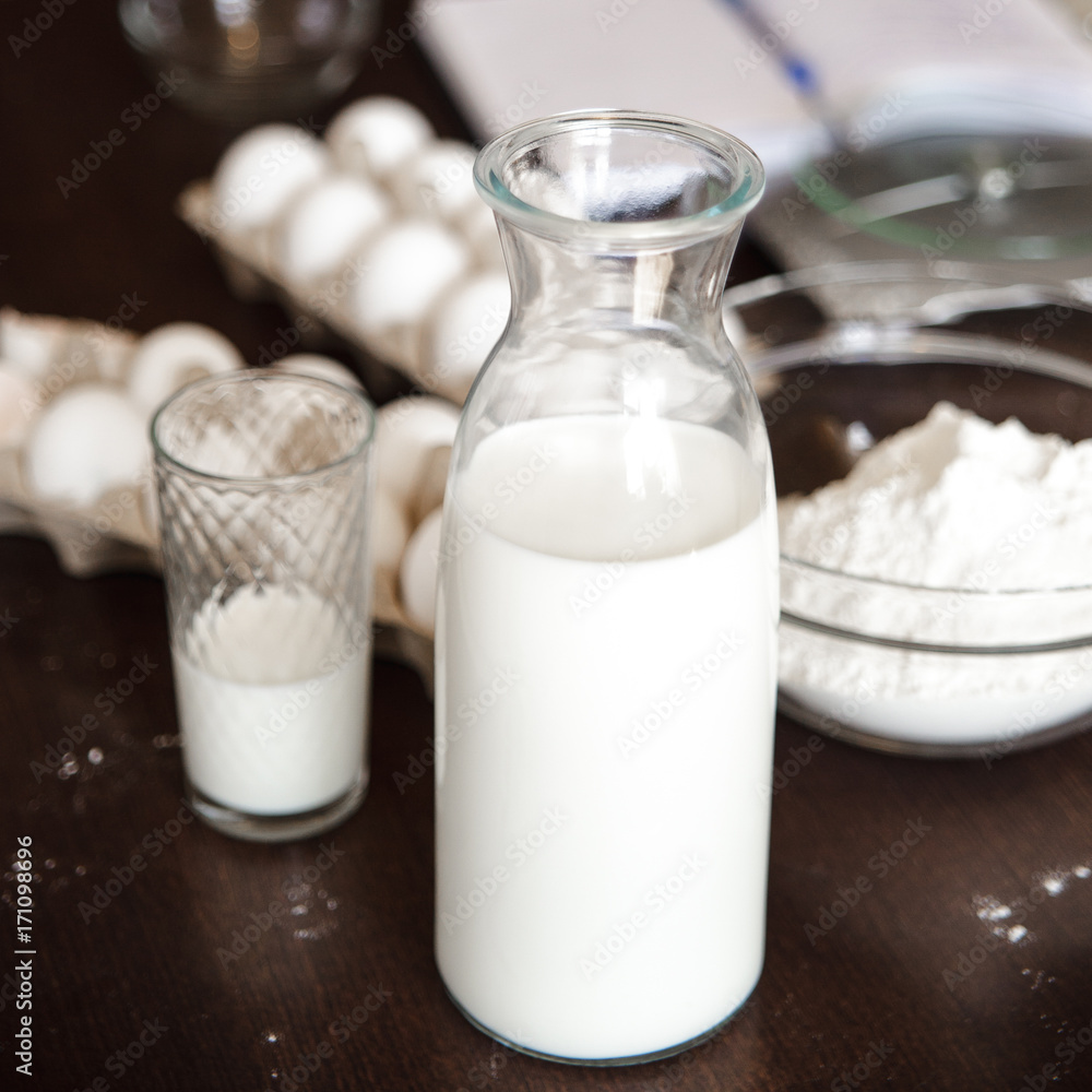 Home cooking still life of eggs in box and milk in glass bottle. Home cooking still life of eggs in box and milk in glass bottle.