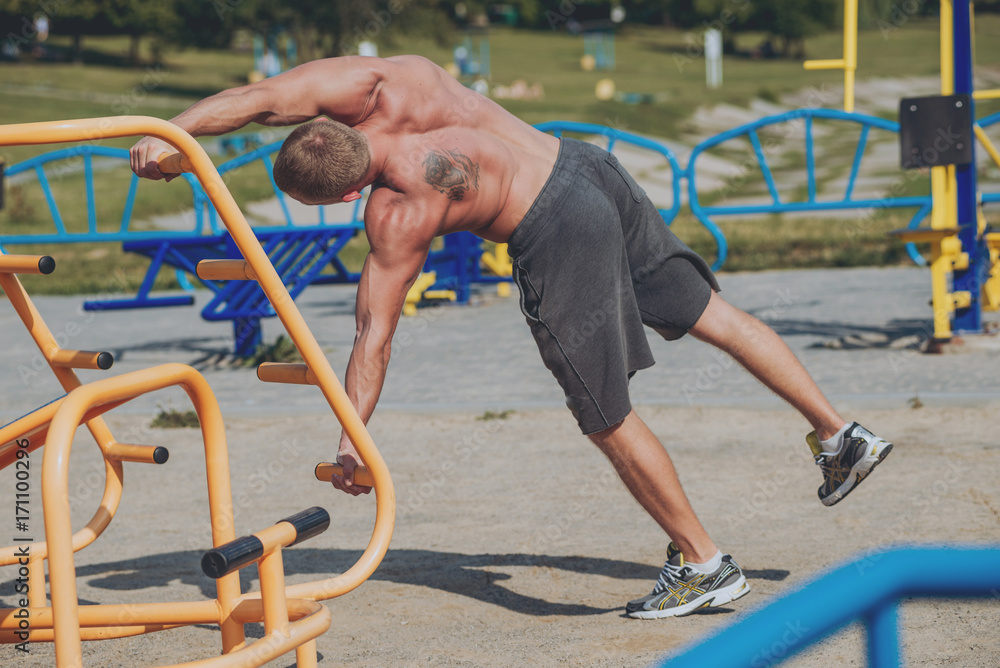 Naklejka premium Young athlete training and doing workout outdoors in city.