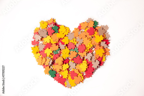 Colorful heart from paper maple leaves on a white background