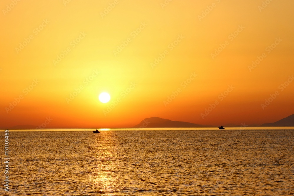 Sonnenaufgang über dem Meer mit Fischerboot
