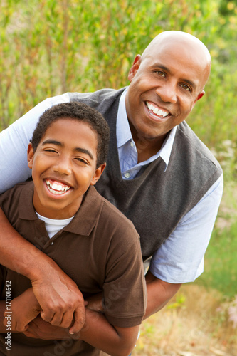 African American father and son talking and laughing.