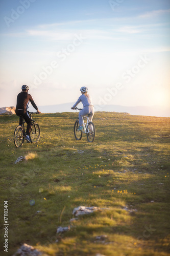 Happy mountainbike couple outdoors have fun together on a summer afternoon © FS-Stock