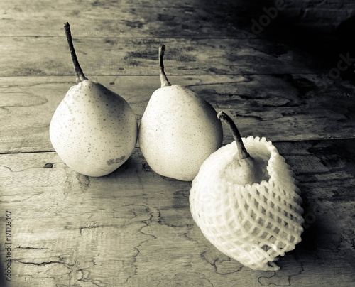 three fresh pears on a rustic background. 