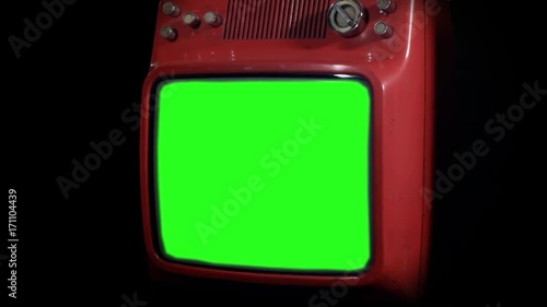 Red TV Set with Green Screen against a Black Background. Zoom In. You can replace green screen with the footage or picture you want. You can do it with “Keying” effect in After Effects. photo