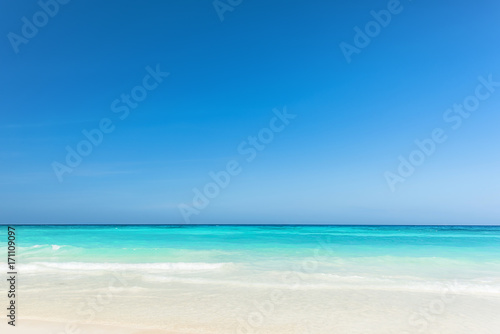 Beautiful gentle wave at the shallow beach with blue sky, Wonderful tropical beach for relaxation © peangdao