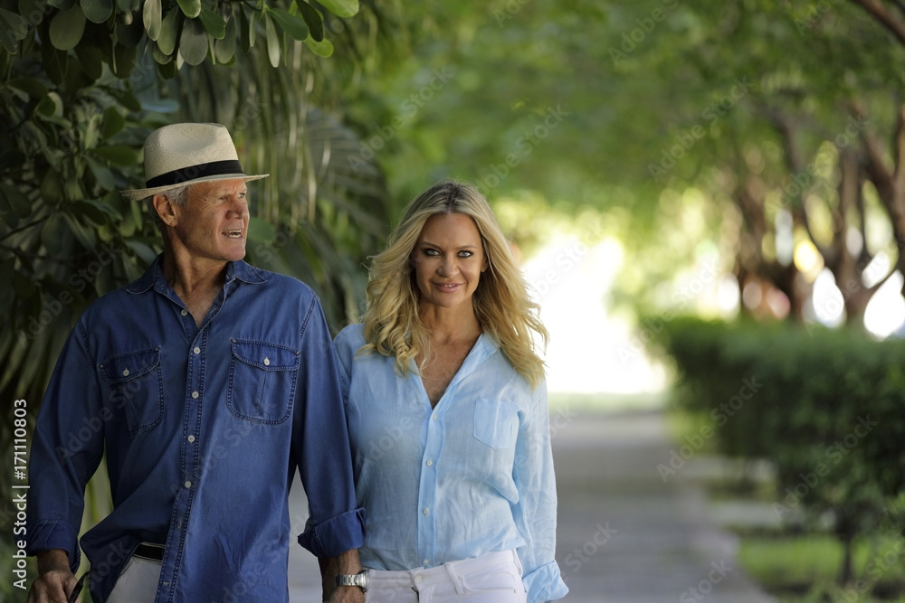 Trending mature couple walking down the street Trending mature couple walking down the street