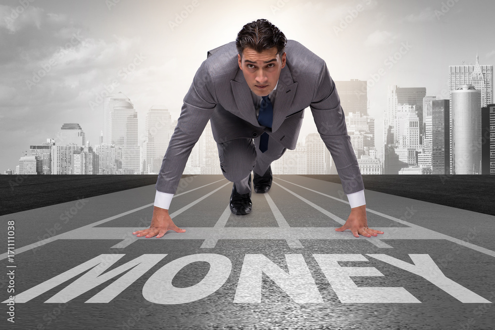 Businessman running towards money on track Businessman running towards money on track