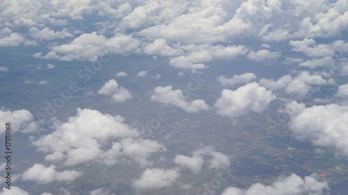 view from the airplane window, fluffy clouds