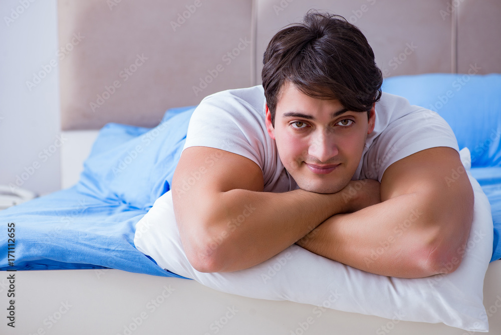 Man suffering from insomnia lying in bed Man suffering from insomnia lying in bed