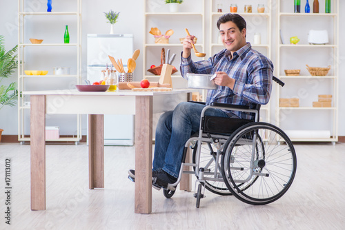 Disabled man preparing soup at kitchen © Elnur