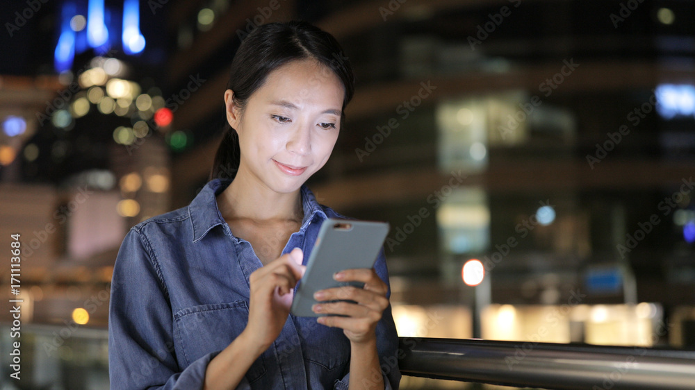Woman looking at mobile phone in Hong Kong Woman looking at mobile phone in Hong Kong
