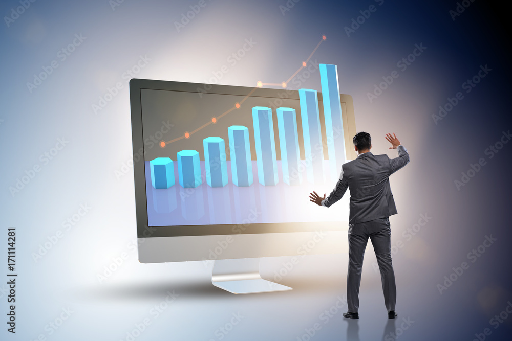 Businessman in economic forecasting concept with charts Businessman in economic forecasting concept with charts