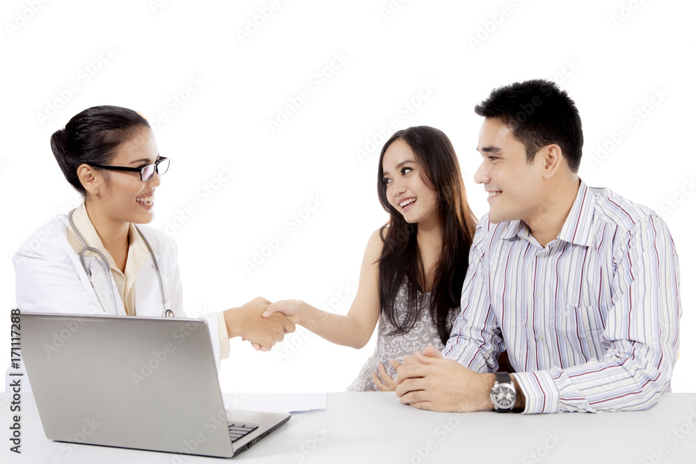 Young couple handshaking with an obstetrician Young couple handshaking with an obstetrician