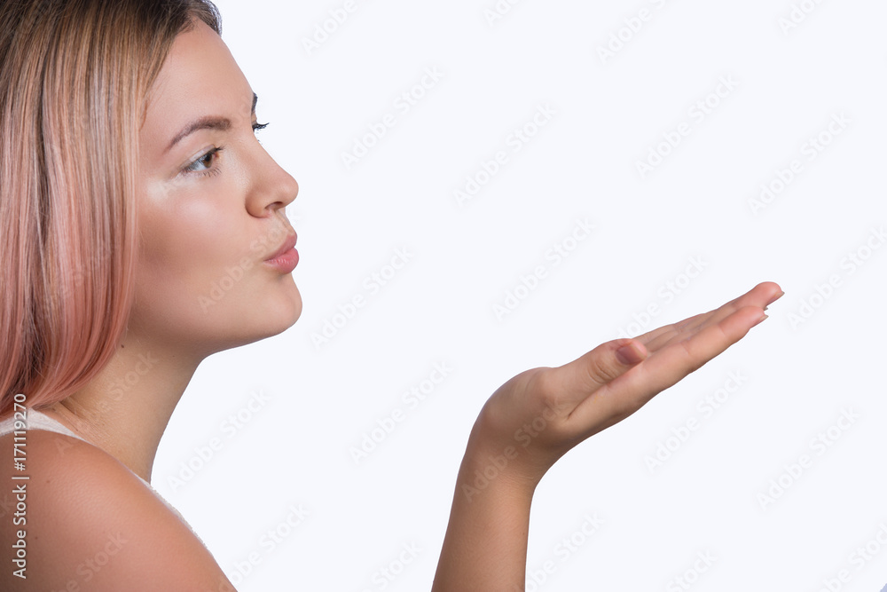 Young cute woman sending air kiss over white background Young cute woman sending air kiss over white background