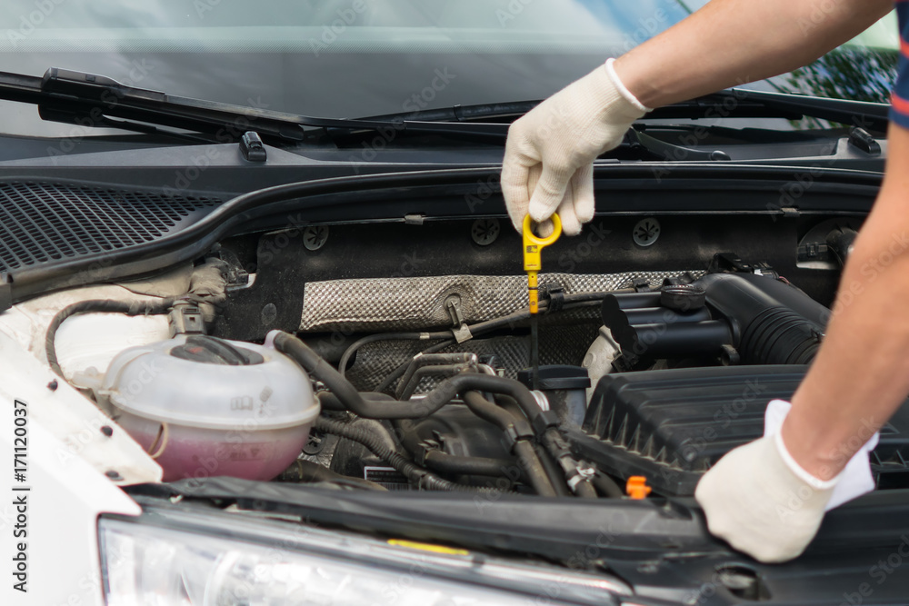 the car master checks the engine oil level the car master checks the engine oil level
