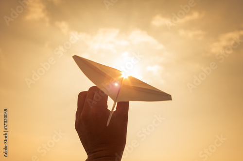 Photography Take off! Hand holding paper airplane in the sky
