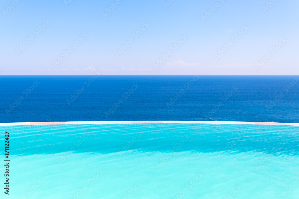 Swimming pool side on blue background of sea and sky