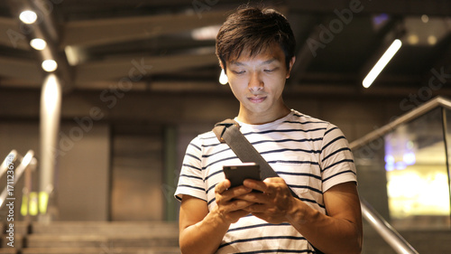 Photography Asian man use of mobile phone at night