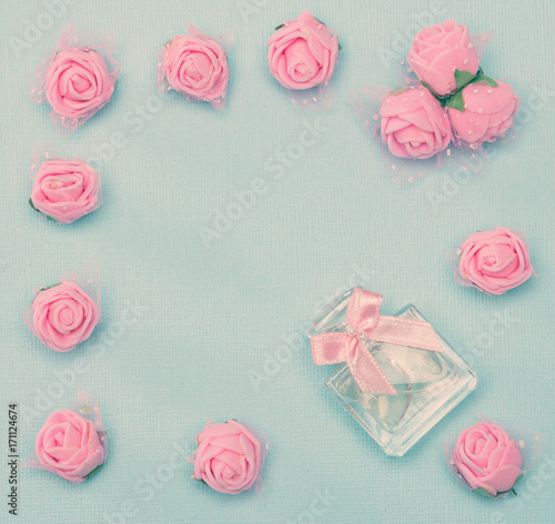 Perfume framed with small pink roses in vintage style