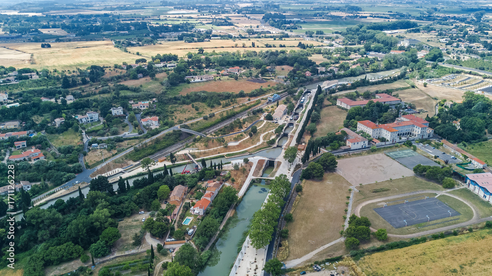 Aerial top view of Fonserannes locks on canal du Midi from above, unesco heritage landmark in France
