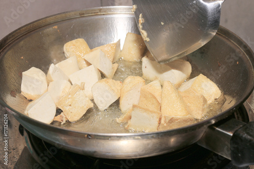 Cooking tofu fries in oil, The process of cooking frying pieces of Tofu on a special grill pan in the kitchen. Vegetarian dishes. Soy Tofu Grilled. Fried Tofu Recipe, Soft focus.
