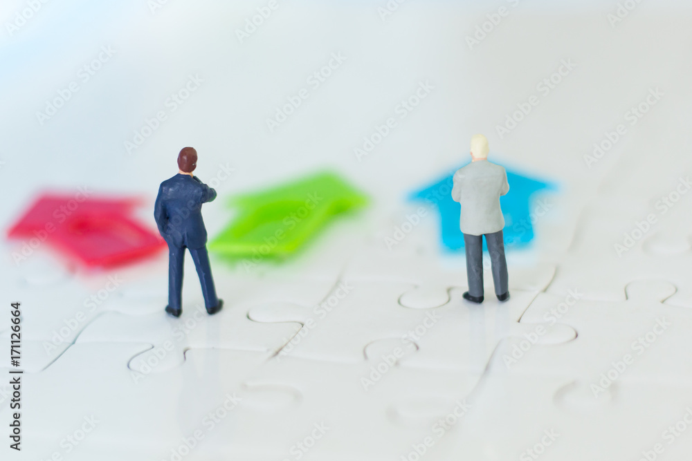 Miniature people: Businessman standing in front of arrow pathway choice using as Business decision concept. Miniature people: Businessman standing in front of arrow pathway choice using as Business decision concept.