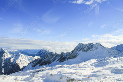 View of a mountain range with snow and clouds © sandradombrovsky