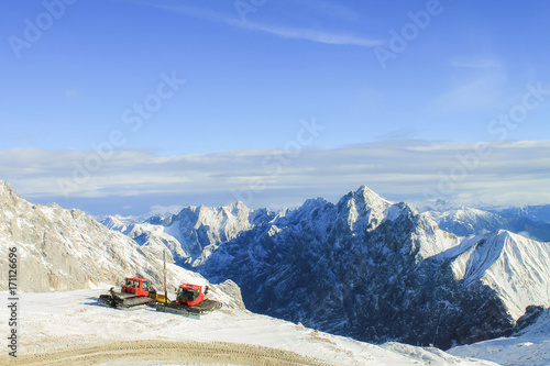 View of a mountain range with snow and clouds