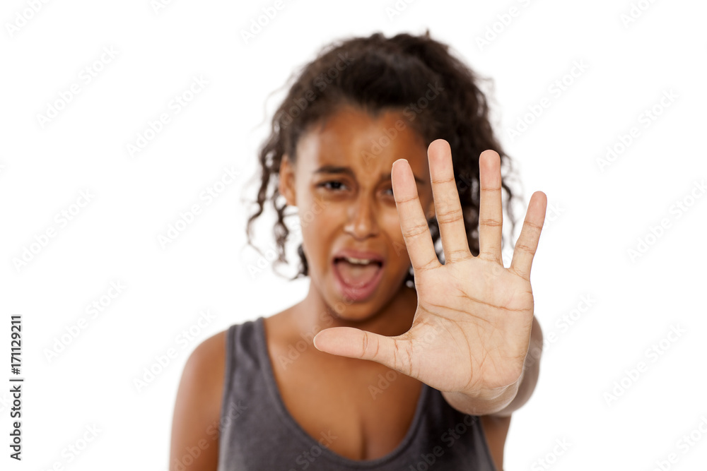 a scared african girl shows a stop hand a scared african girl shows a stop hand
