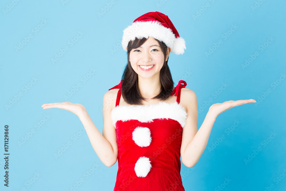 portrait of asian santa woman isolated on blue background