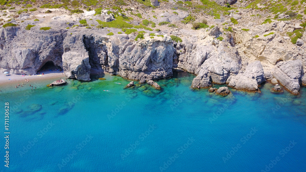 August 2017: Aerial drone photo of paradise beach of Traganou with small caves and turquoise clear waters, Rhodes island, Dodecanese, Aegean, Greece