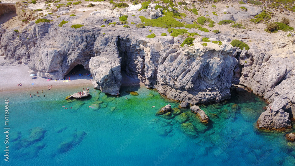 August 2017: Aerial drone photo of paradise beach of Traganou with small caves and turquoise clear waters, Rhodes island, Dodecanese, Aegean, Greece August 2017: Aerial drone photo of paradise beach of Traganou with small caves and turquoise clear waters, Rhodes island, Dodecanese, Aegean, Greece