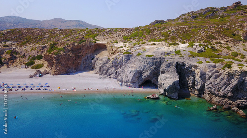 August 2017: Aerial drone photo of paradise beach of Traganou with small caves and turquoise clear waters, Rhodes island, Dodecanese, Aegean, Greece © aerial-drone