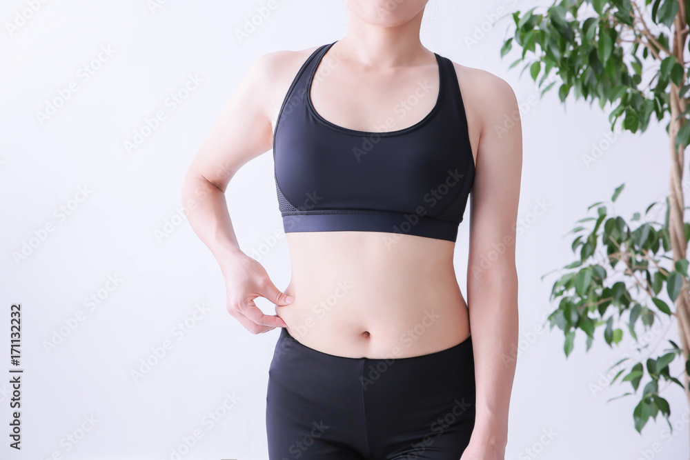 お腹の贅肉をつかむ女性
お腹の贅肉をつかむ女性