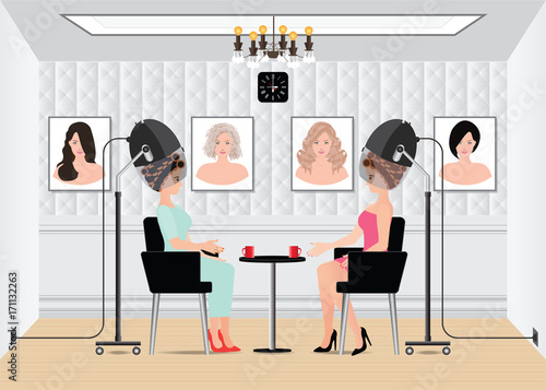 Women waiting for while drying under hairdryer in beauty salon.