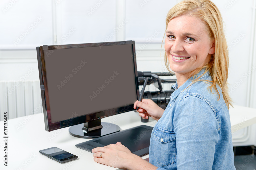 Young graphic designer working on computer using tablet Young graphic designer working on computer using tablet