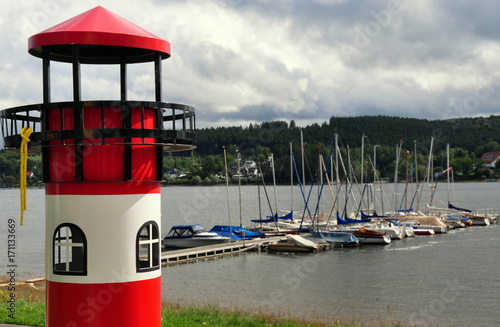 Kleiner Yachthafen am Möhnestausee mit Leuchtturm im Vordergrund photo