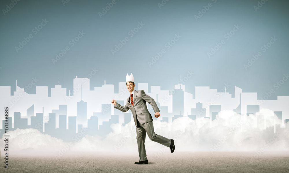 King businessman in elegant suit running and blue cityscape silh King businessman in elegant suit running and blue cityscape silh