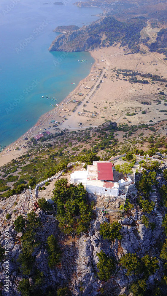 Fototapeta premium August 2017: Aerial drone photo of famous Tsabika monastery overlooking iconic Tsabika bay from the cliff with clear turquoise waters, Rhodes island, Aegean, Dodecanese, Greece